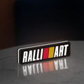 Ralliart LED lightbox standing on a desk from an angled side view with white glow