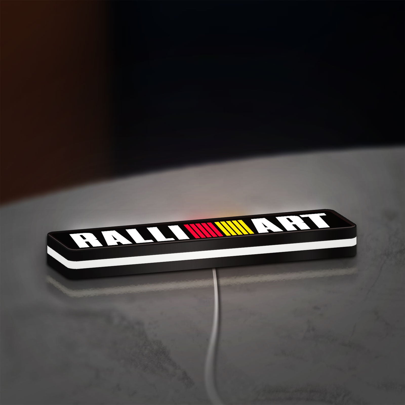 Ralliart LED lightbox lying flat on a desk with white glow