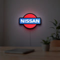 Nissan LED lightbox hanging on a room wall with soft red light