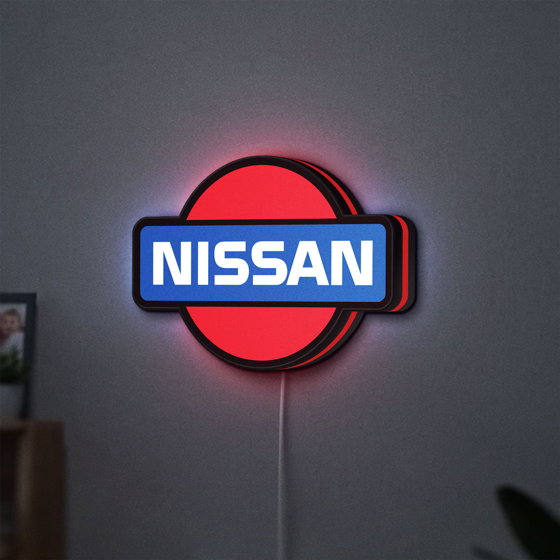 Nissan LED lightbox hanging on a wall with red glow