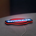Nissan LED lightbox lying flat on a desk with red glow