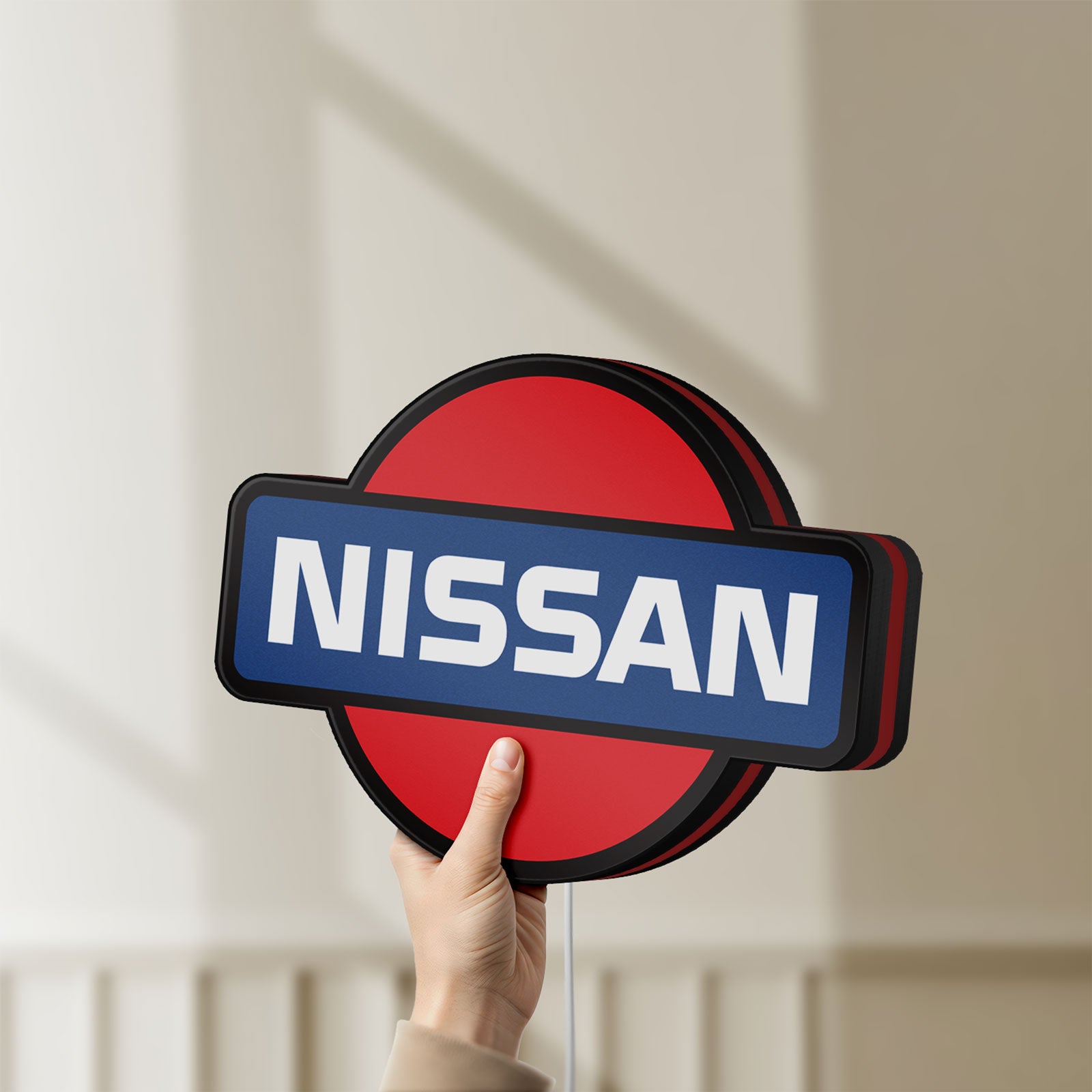Unlit Nissan LED lightbox held by hand to show size and details