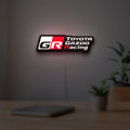 Toyota Gazoo Racing LED lightbox hanging on a room wall with soft white light