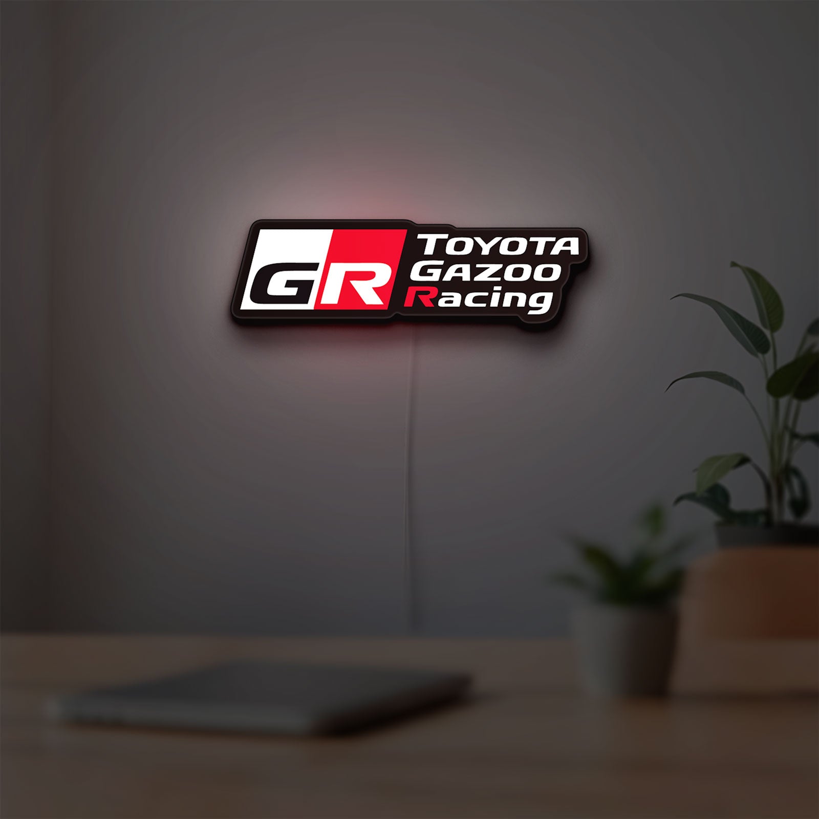 Toyota Gazoo Racing LED lightbox hanging on a room wall with soft white light