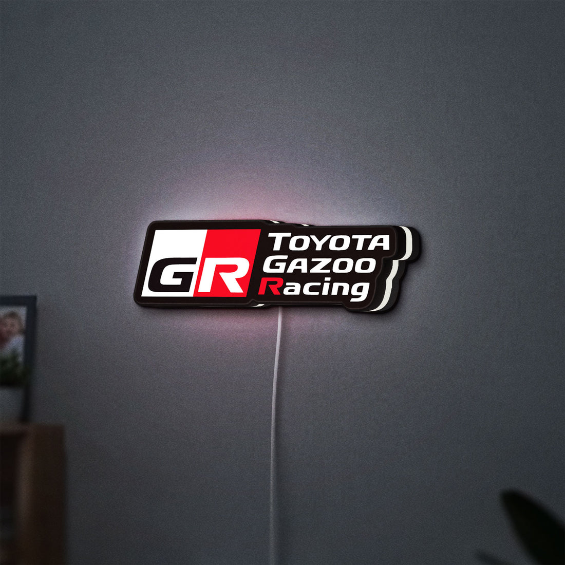 Toyota Gazoo Racing LED lightbox hanging on a wall with white glow