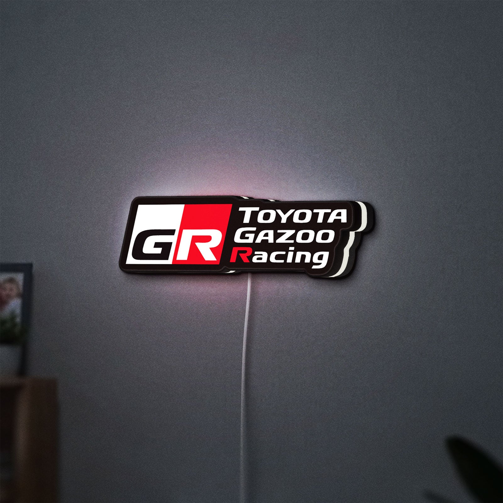 Toyota Gazoo Racing LED lightbox hanging on a wall with white glow
