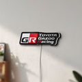 Unlit Toyota Gazoo Racing LED lightbox mounted on a wall in daylight