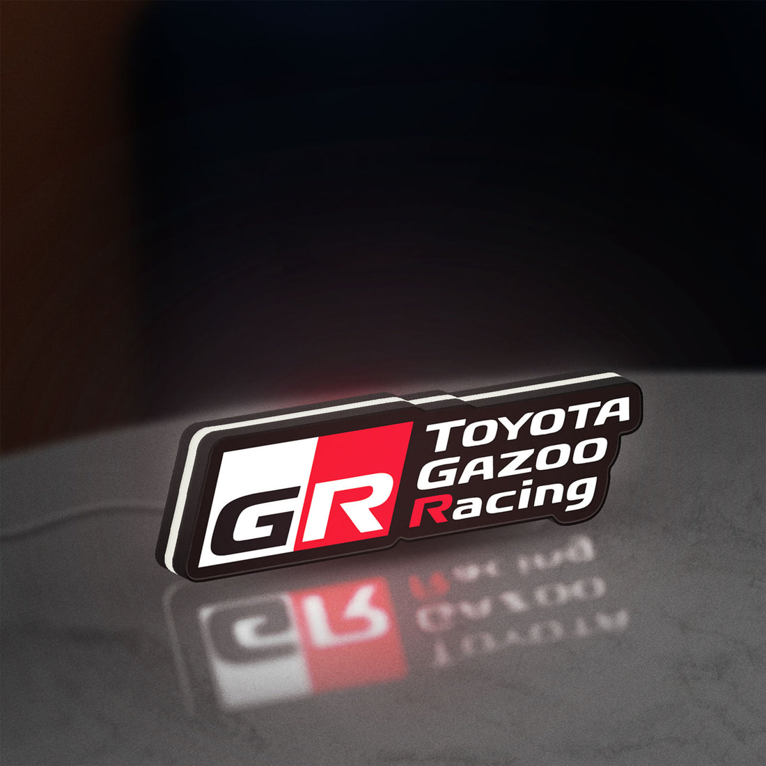 Toyota Gazoo Racing LED lightbox hanging on a wall with white glow