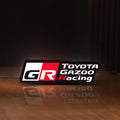 Front view of Toyota Gazoo Racing LED lightbox sign glowing on a wooden desk