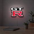GT-R LED lightbox hanging on a room wall with soft white light