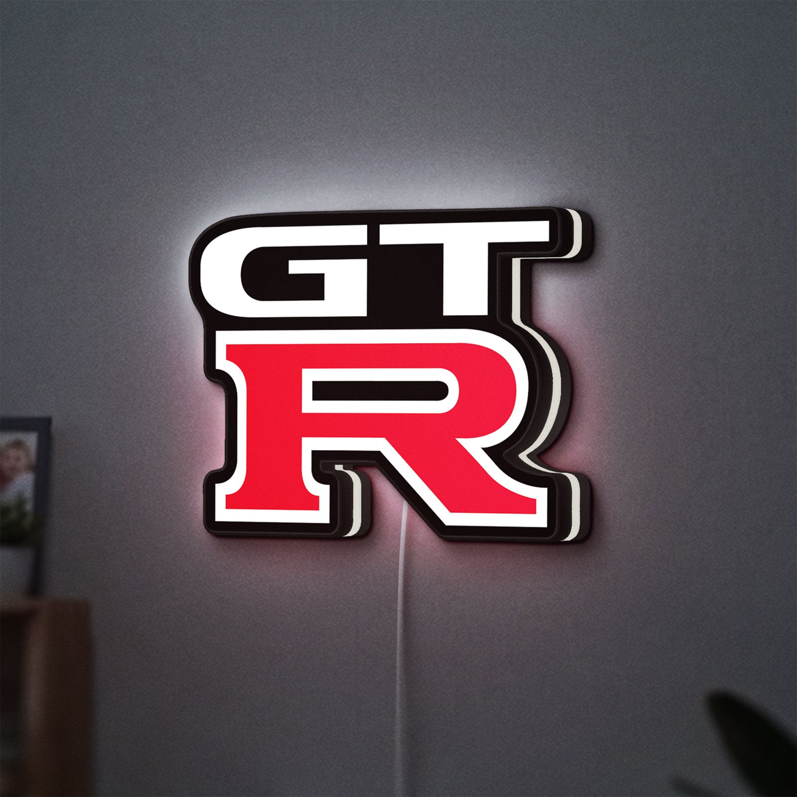 GT-R LED lightbox hanging on a wall with white glow