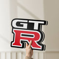 Unlit GT-R LED lightbox held by hand to show size and details