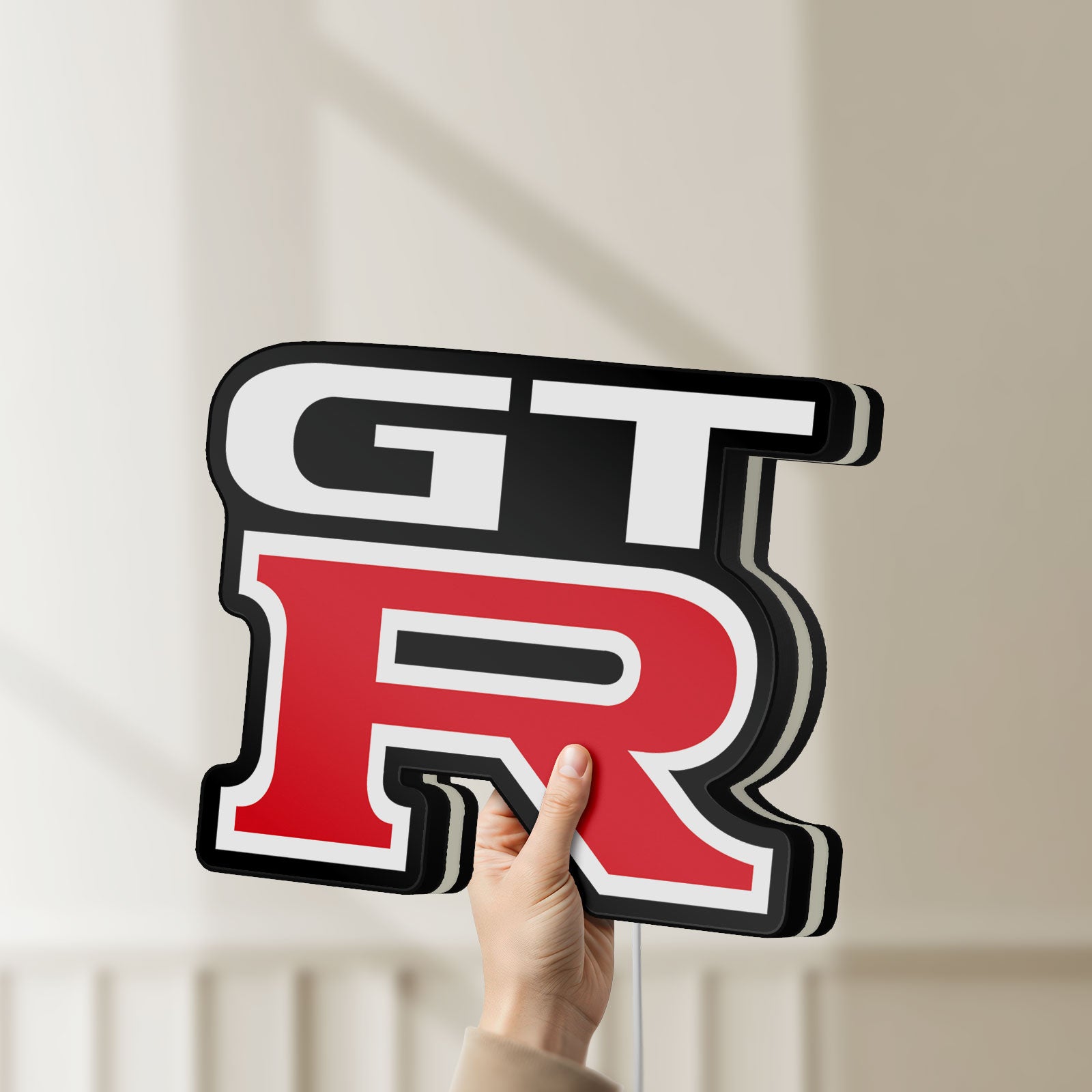 Unlit GT-R LED lightbox held by hand to show size and details
