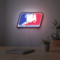 AMA Motocross LED lightbox hanging on a room wall with soft red light