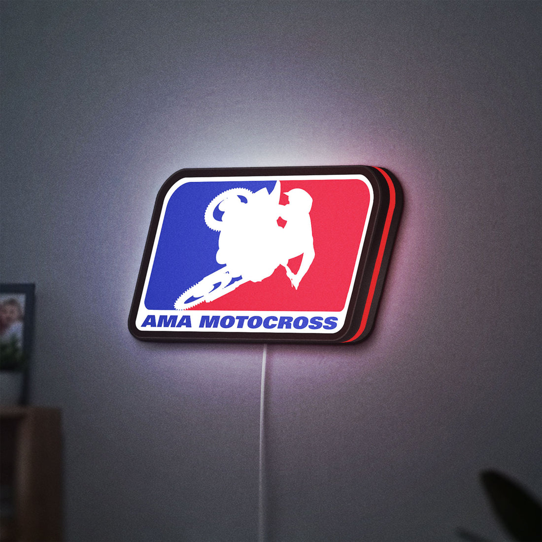 AMA Motocross LED lightbox hanging on a wall with red glow