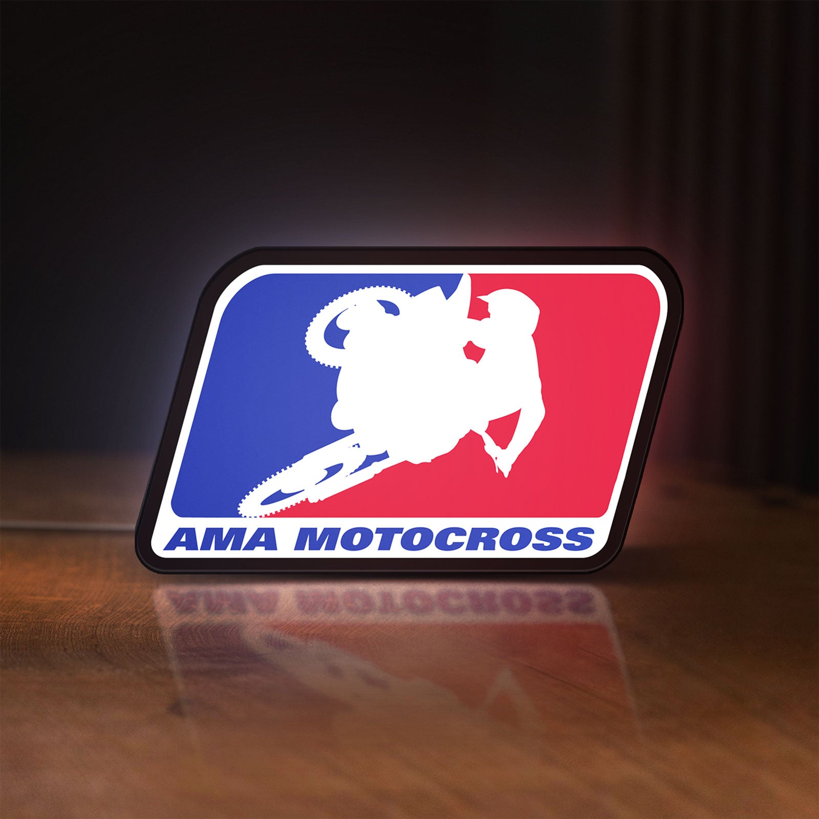 Front view of AMA Motocross LED lightbox sign glowing on a wooden desk