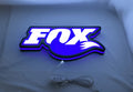Illuminated flat lay angled view of Fox Racing Shox 3D LED Sign in 40cm, perfect for garage and man cave decor