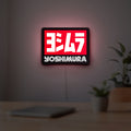 Yoshimura LED lightbox hanging on a room wall with soft red light