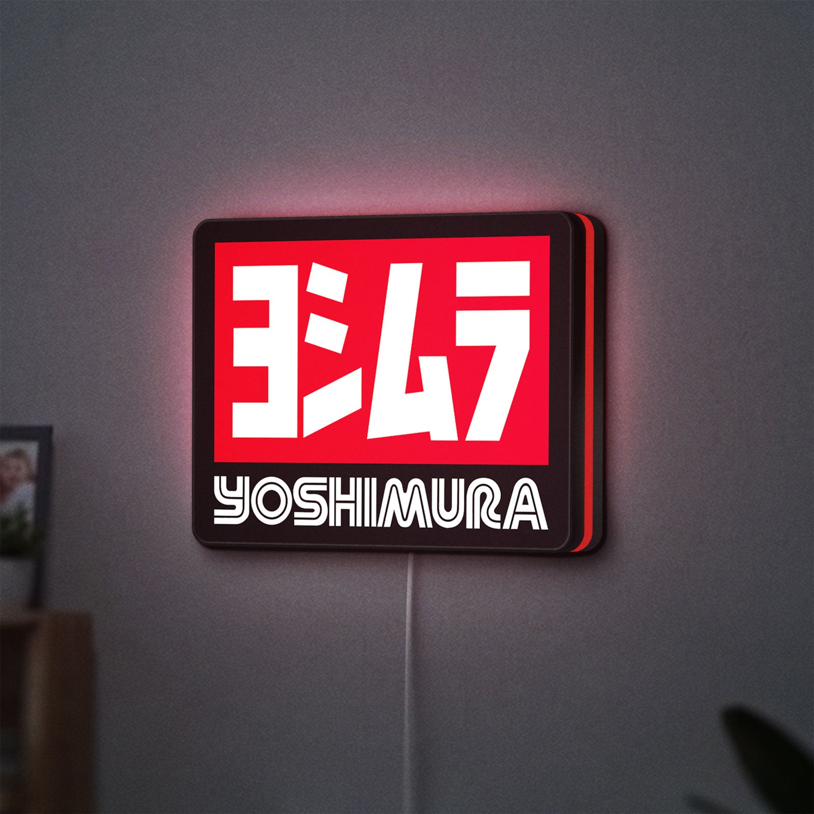 Yoshimura LED lightbox hanging on a wall with red glow