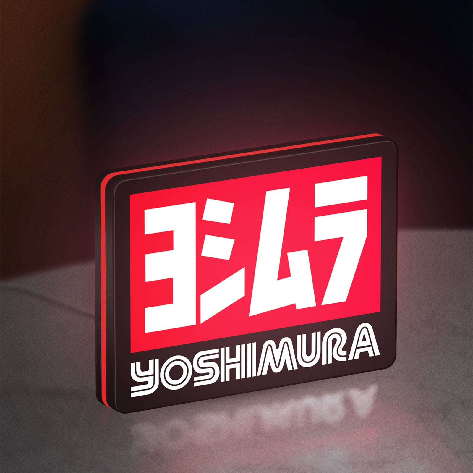 Yoshimura LED lightbox standing on a desk from an angled side view with red glow