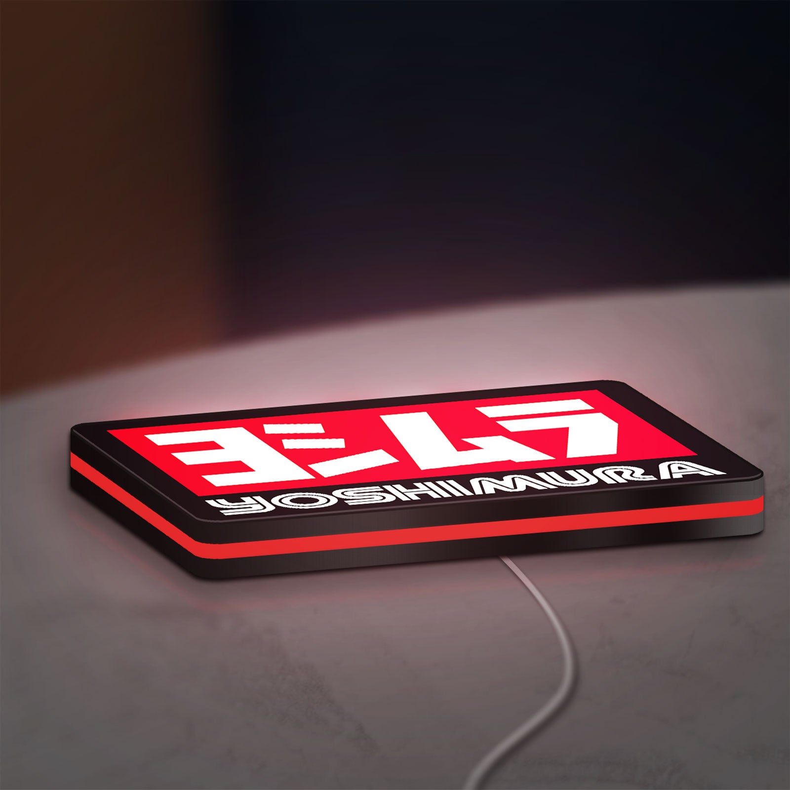 Yoshimura LED lightbox lying flat on a desk with red glow