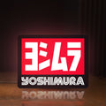 Front view of Yoshimura LED lightbox sign glowing on a wooden desk