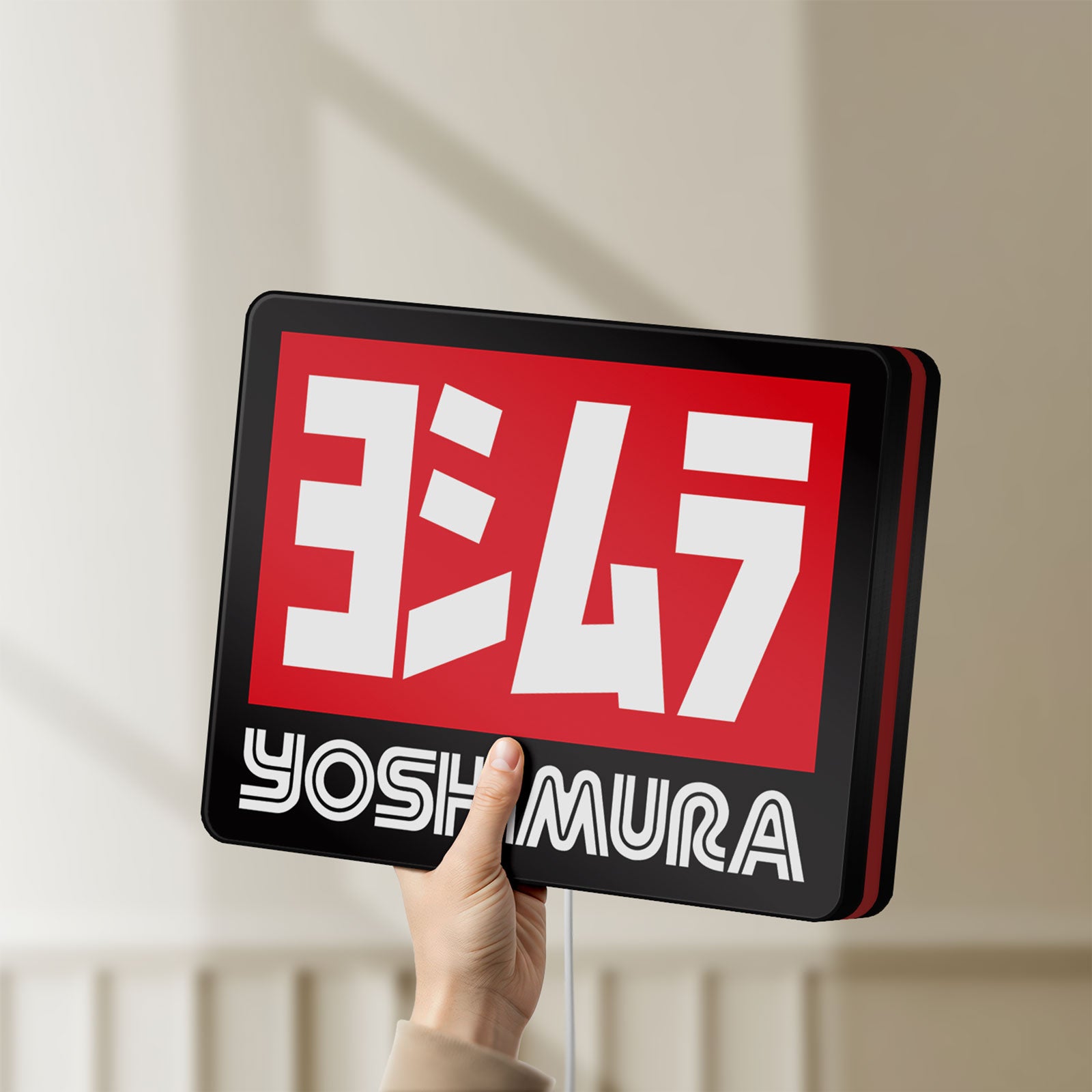 Unlit Yoshimura LED lightbox held by hand to show size and details