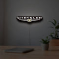 Chrysler LED lightbox hanging on a room wall with soft white light