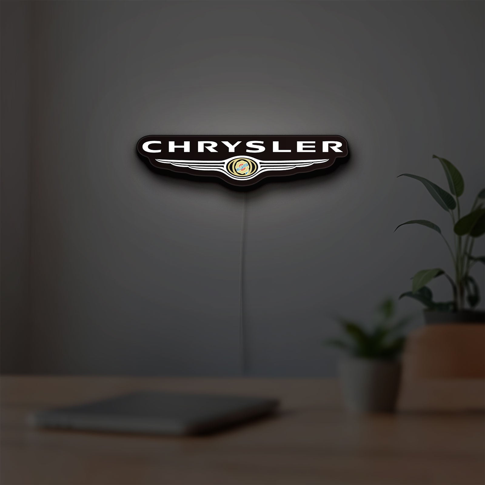 Chrysler LED lightbox hanging on a room wall with soft white light