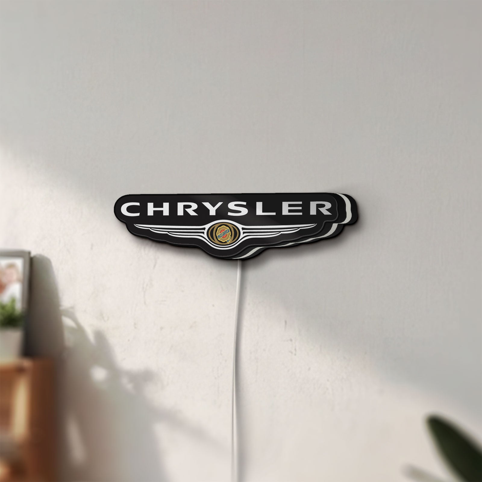 Unlit Chrysler LED lightbox mounted on a wall in daylight
