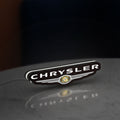 Chrysler LED lightbox standing on a desk from an angled side view with white glow