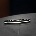 Chrysler LED lightbox lying flat on a desk with white glow