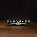 Front view of Chrysler LED lightbox sign glowing on a wooden desk