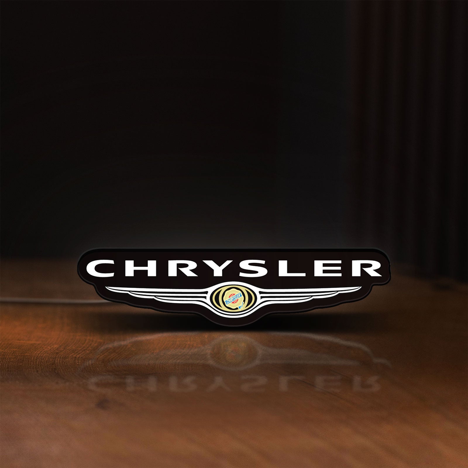 Front view of Chrysler LED lightbox sign glowing on a wooden desk