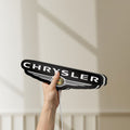 Unlit Chrysler LED lightbox held by hand to show size and details