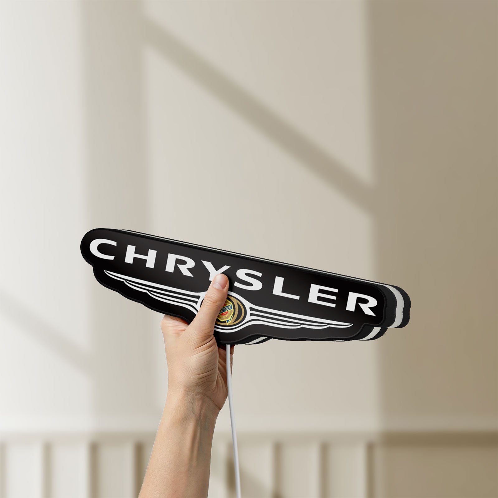 Unlit Chrysler LED lightbox held by hand to show size and details