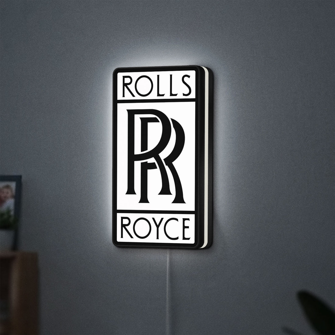 Rolls-Royce LED lightbox hanging on a wall with white glow