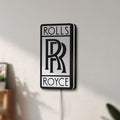 Unlit Rolls-Royce LED lightbox mounted on a wall in daylight