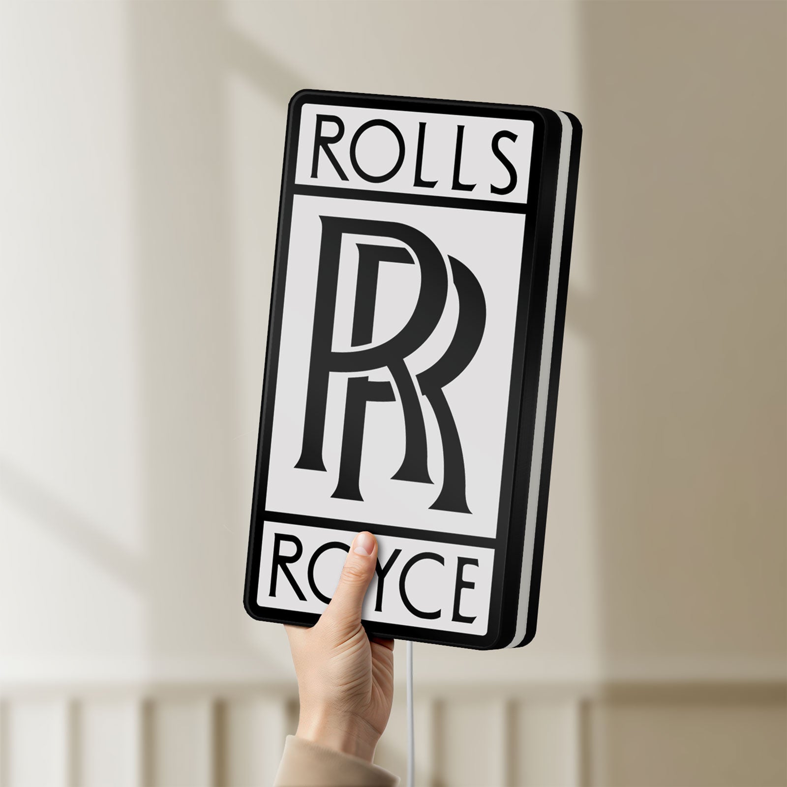 Unlit Rolls-Royce LED lightbox held by hand to show size and details
