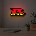 Suzuki GSX-R LED lightbox hanging on a room wall with soft yellow light