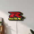 Unlit Suzuki GSX-R LED lightbox mounted on a wall in daylight