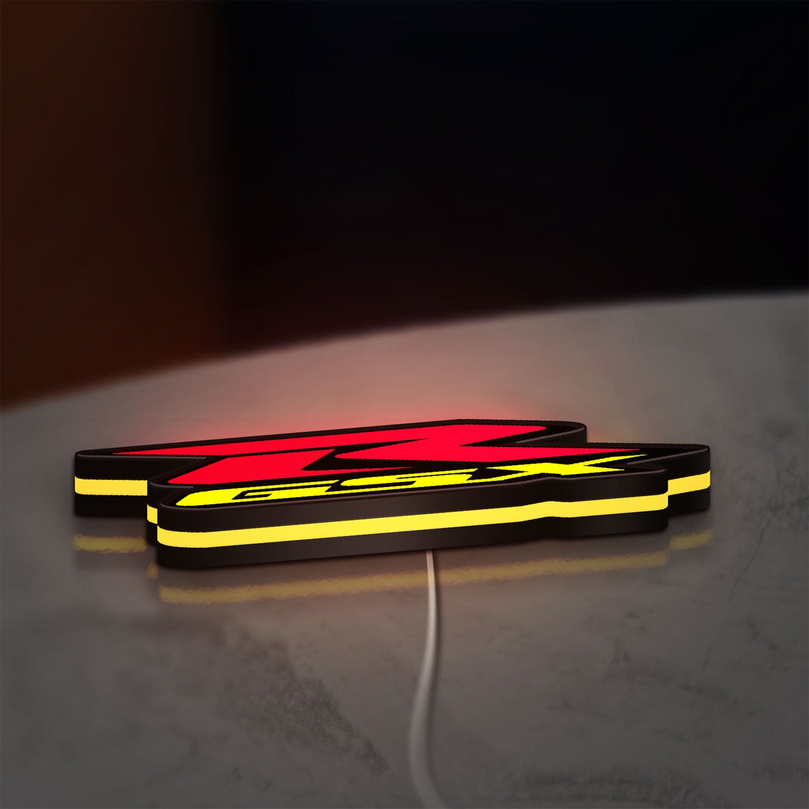 Suzuki GSX-R LED lightbox lying flat on a desk with yellow glow