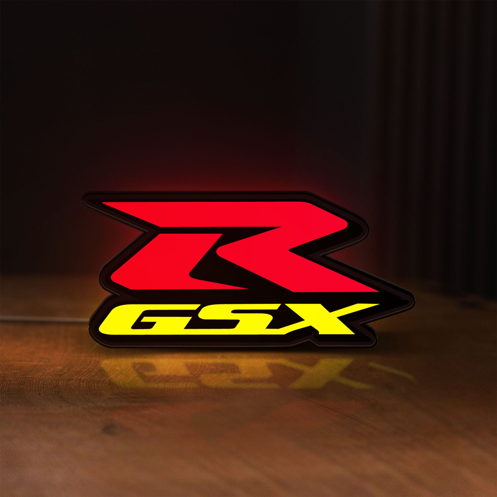 Front view of Suzuki GSX-R LED lightbox sign glowing on a wooden desk