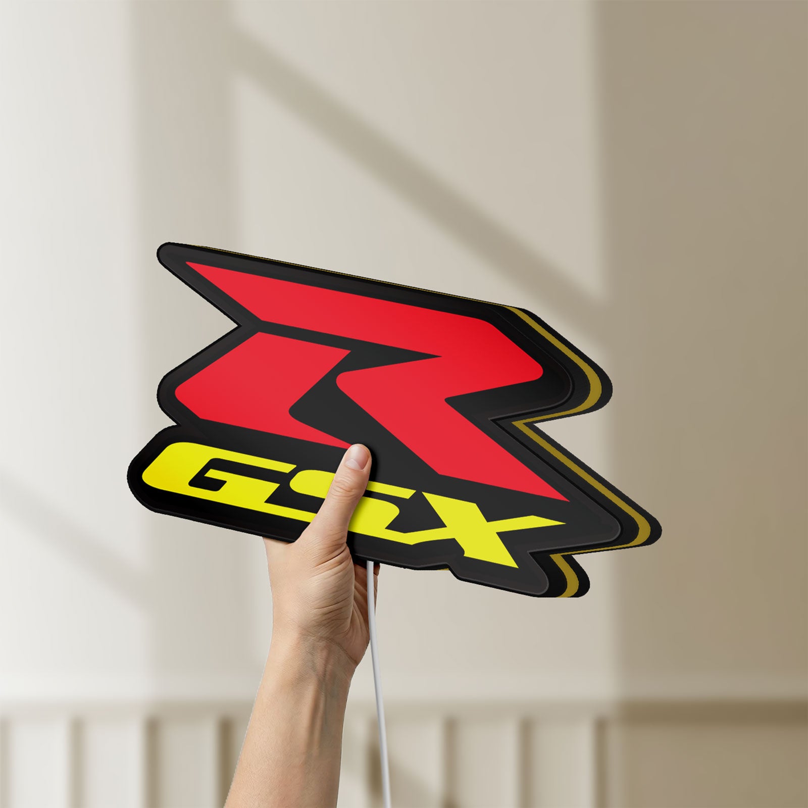 Unlit Suzuki GSX-R LED lightbox held by hand to show size and details