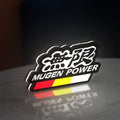 Mugen LED lightbox standing on a desk from an angled side view with white glow