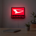 Daihatsu LED lightbox hanging on a room wall with soft red light