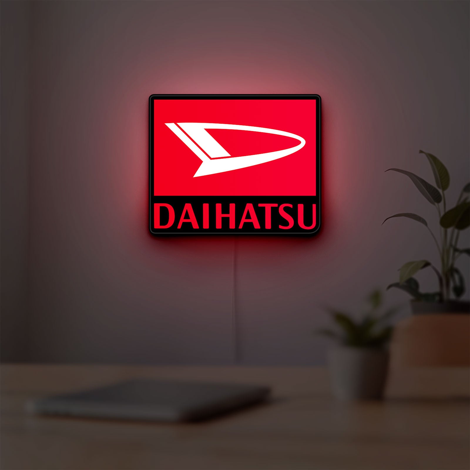 Daihatsu LED lightbox hanging on a room wall with soft red light