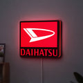 Daihatsu LED lightbox hanging on a wall with red glow