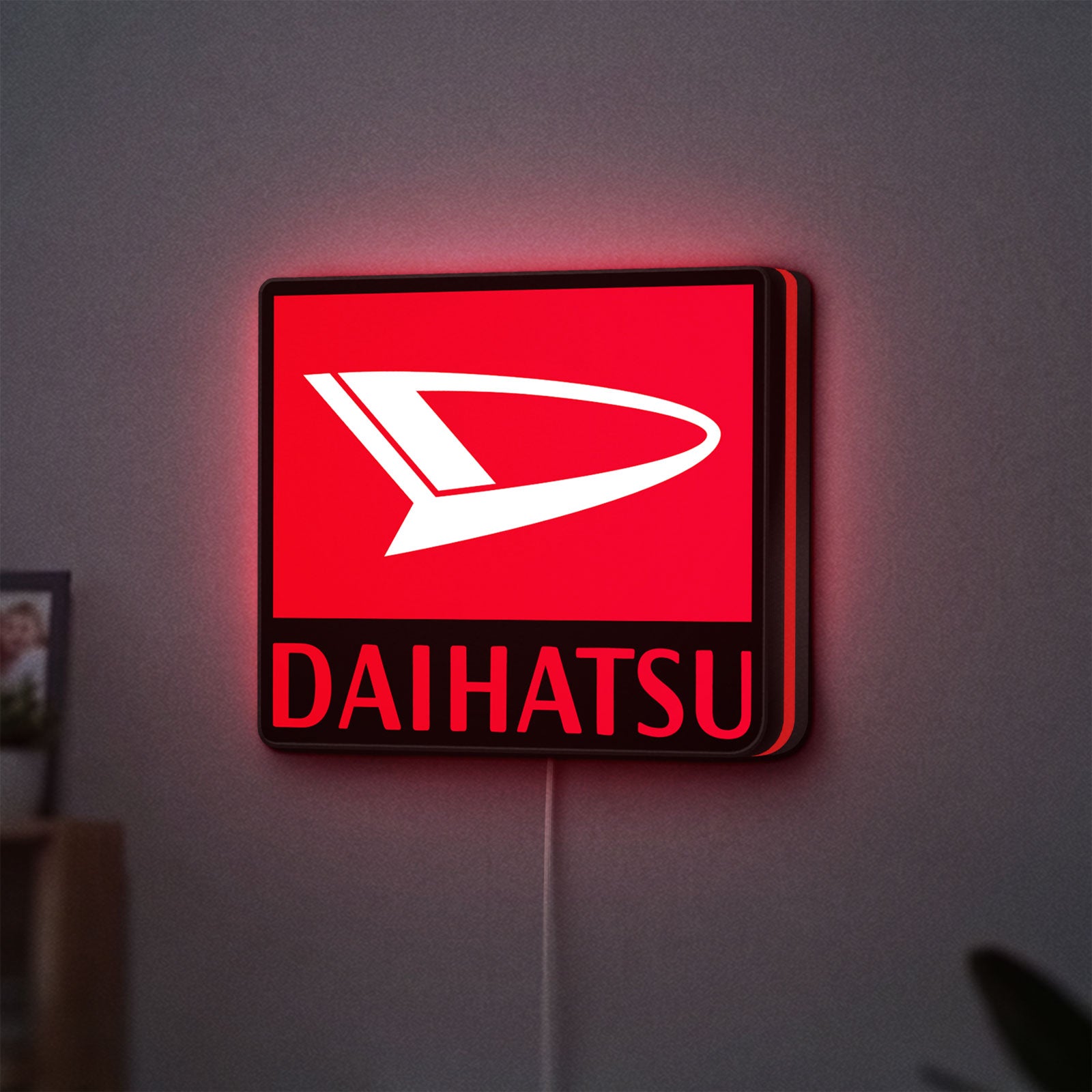 Daihatsu LED lightbox hanging on a wall with red glow