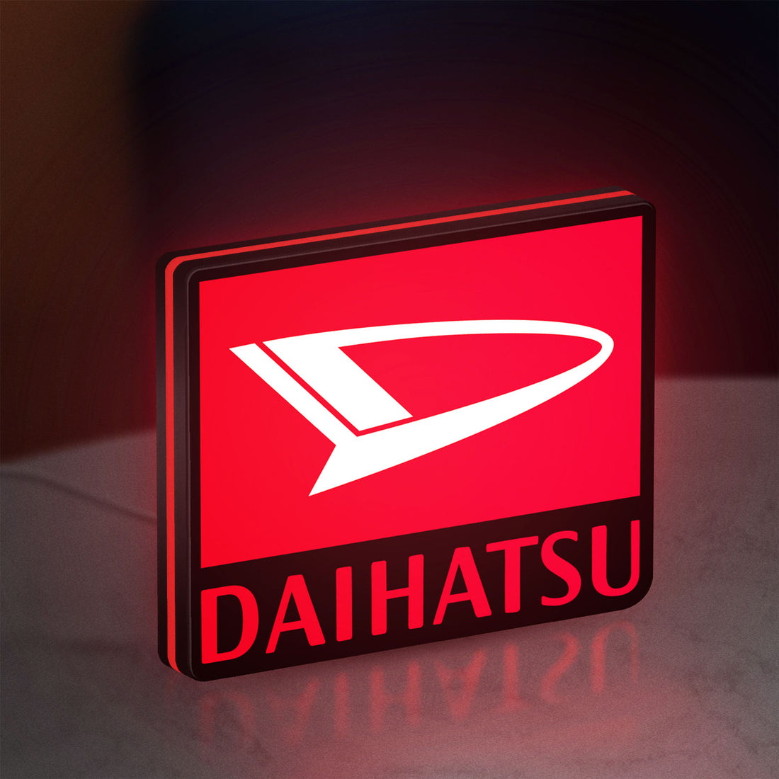 Daihatsu LED lightbox hanging on a wall with red glow